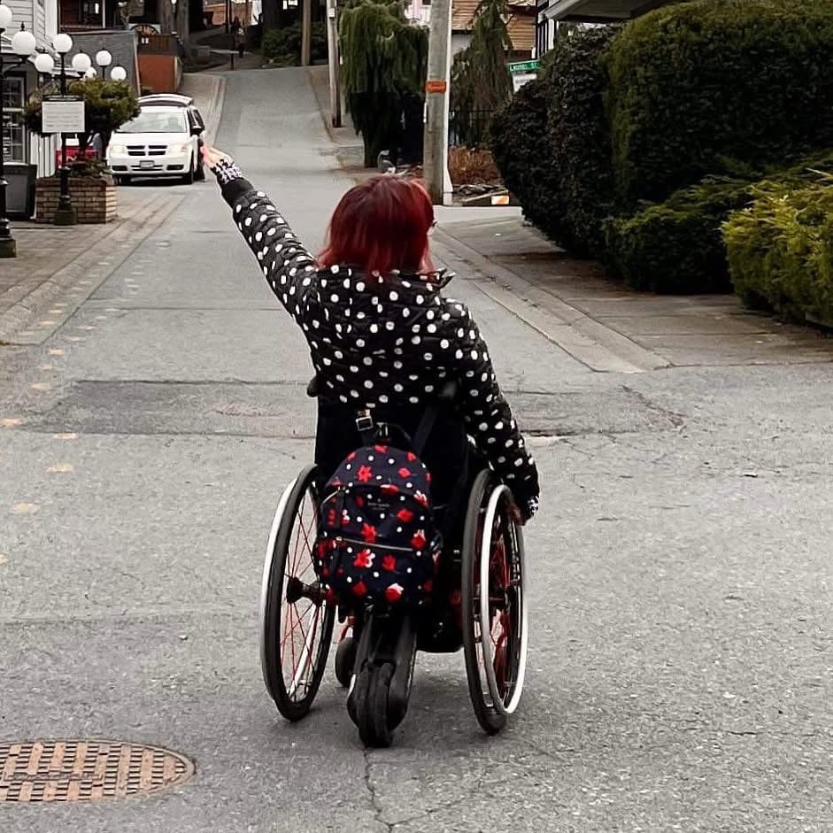 The SmartDrive device is an electronic wheel that's fitted to the back of a wheelchair. It adds extra power to help the user negotiate hills and rough terrain.