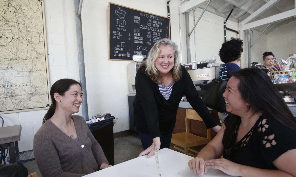 Christine Moore talks with customers.