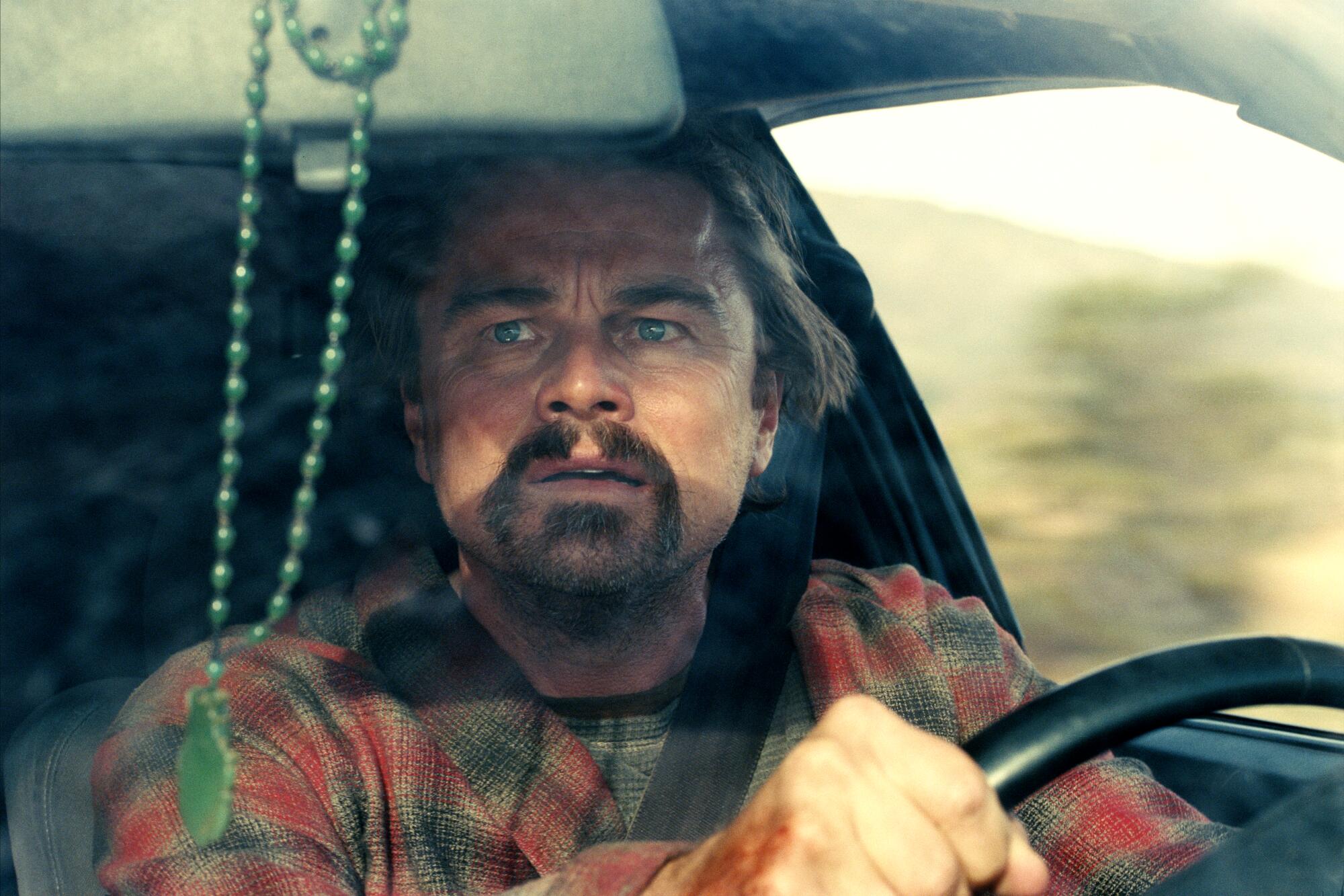 Leonardo DiCaprio drives a car in "One Battle After Another." 