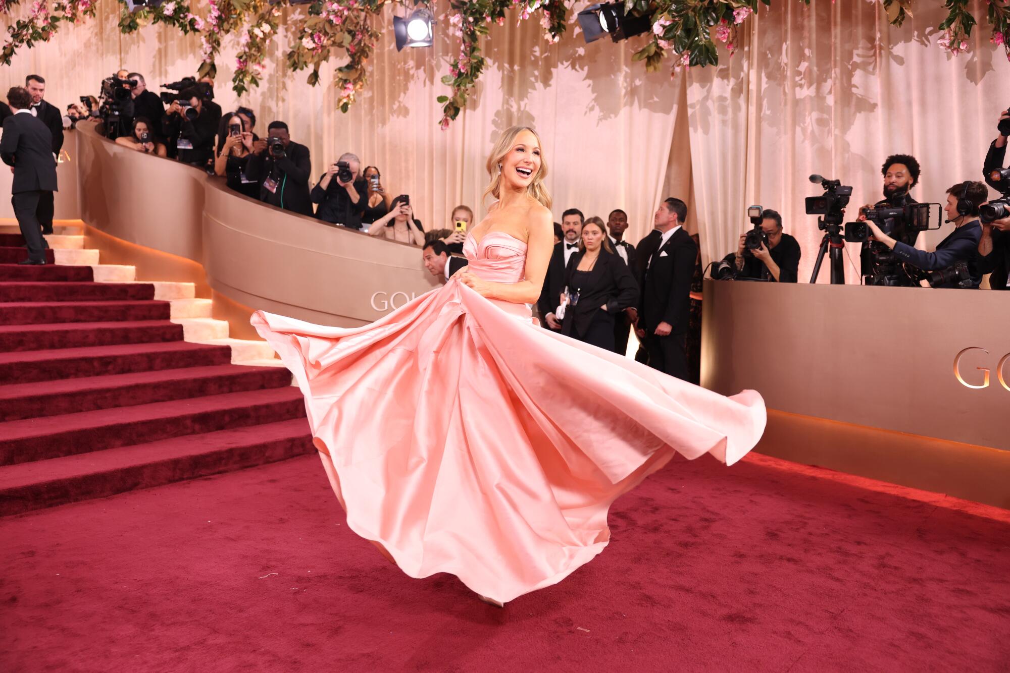 Nikki Glaser twirls her pale pink gown. 