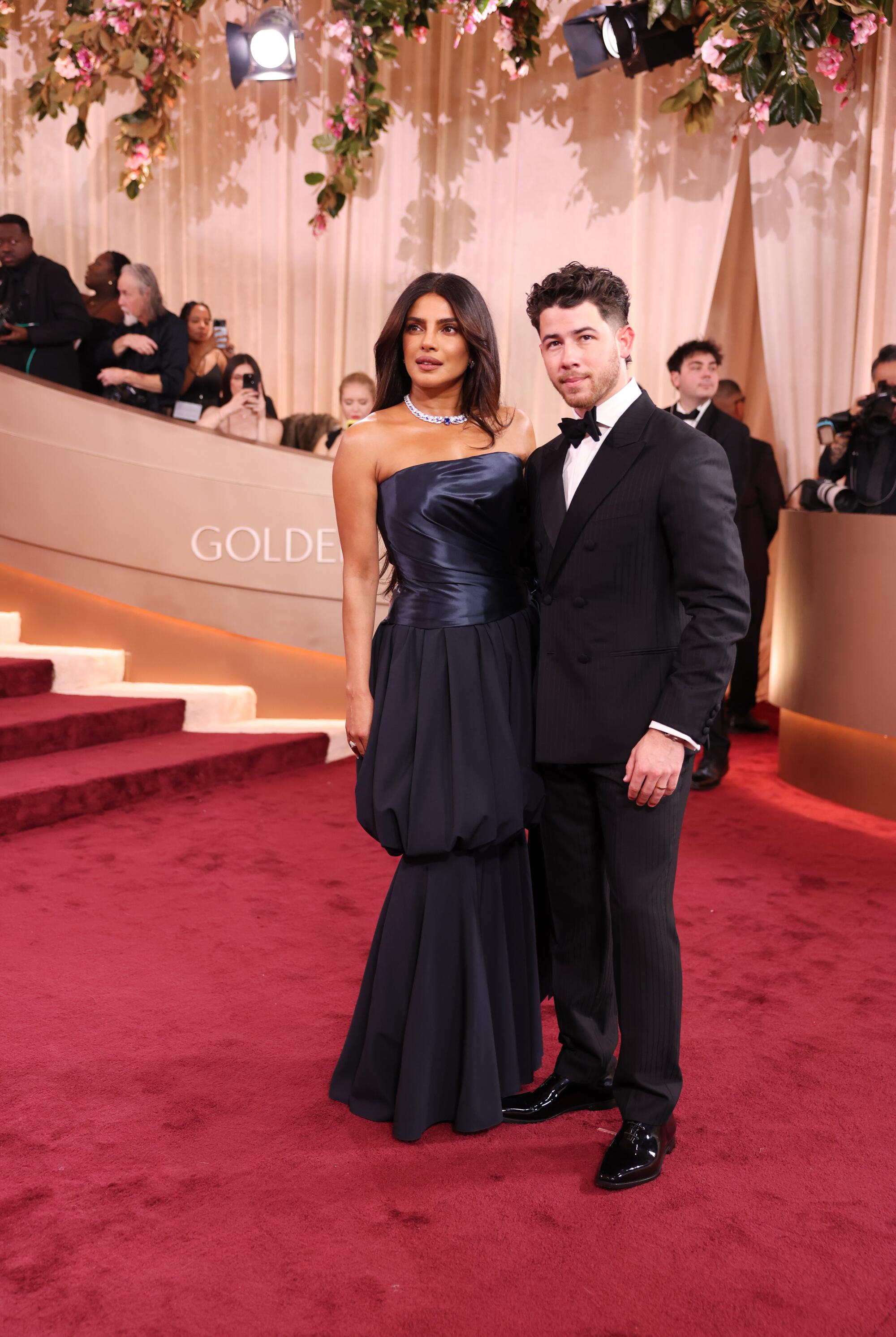 Priyanka Chopra Jonas and Nick Jonas pose on the red carpet.