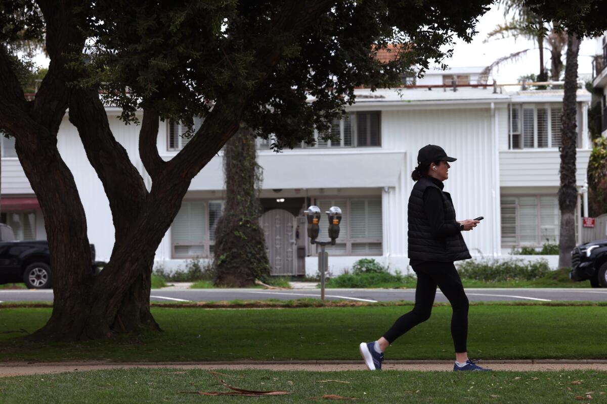 a woman walks through a park