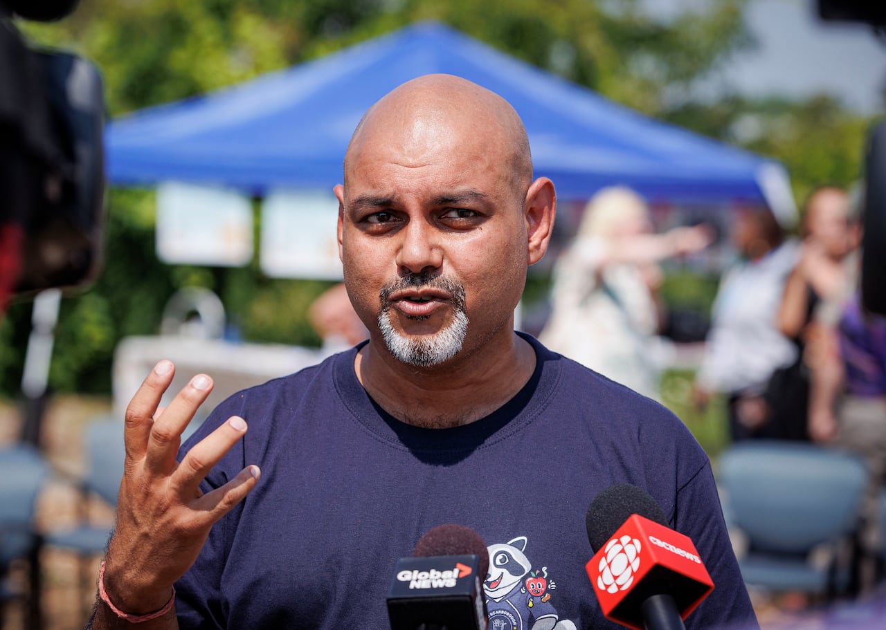 A man giving an interview outside.
