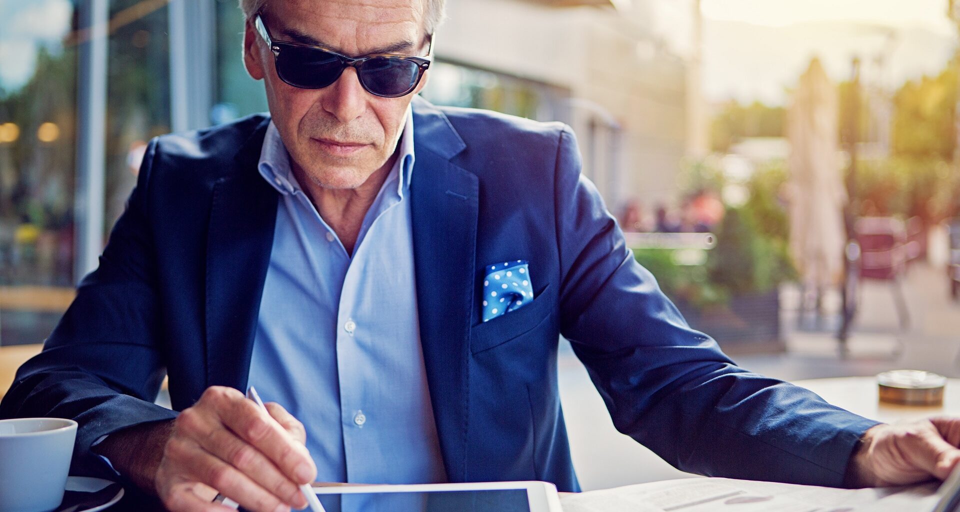 Businessman is working with digital tablet in the cafe stock photo