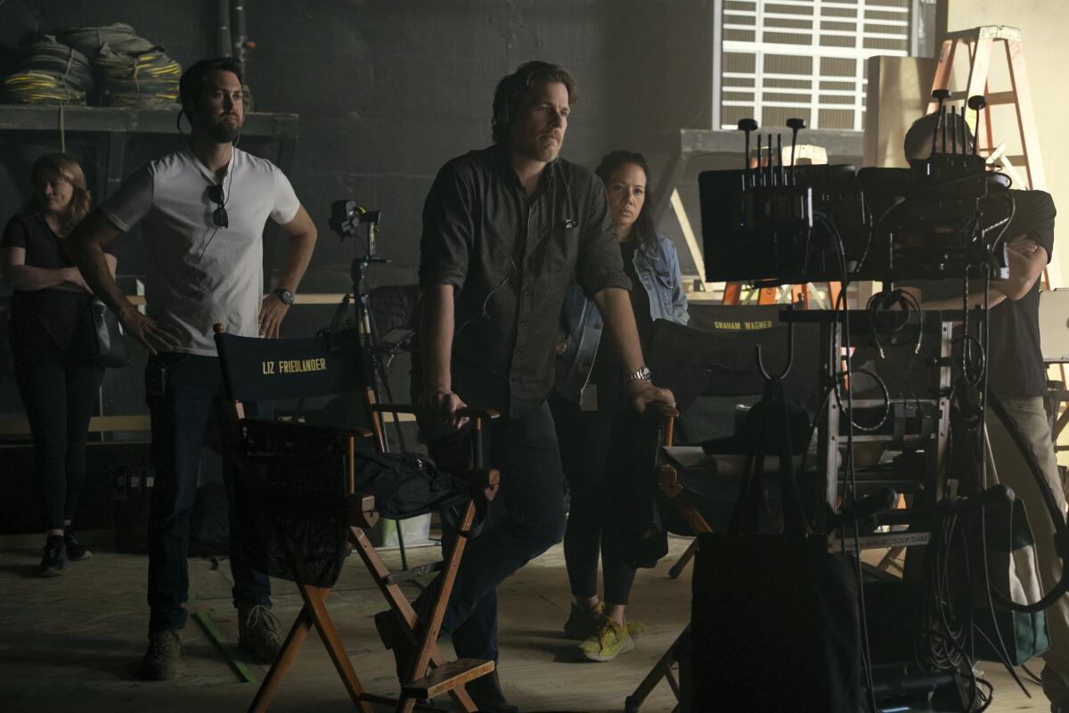 people gathered around monitors 