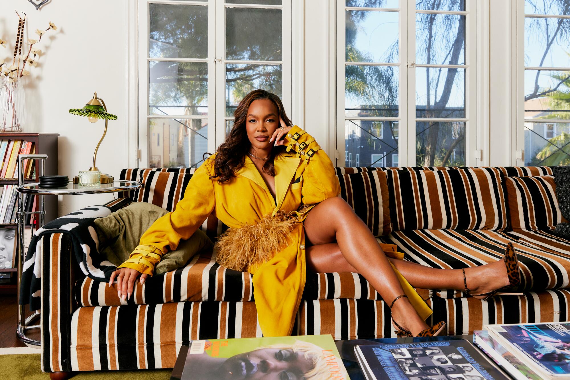 Brittany Hampton wears a RC Caylan trench coat and Gianvito Rossi pumps.