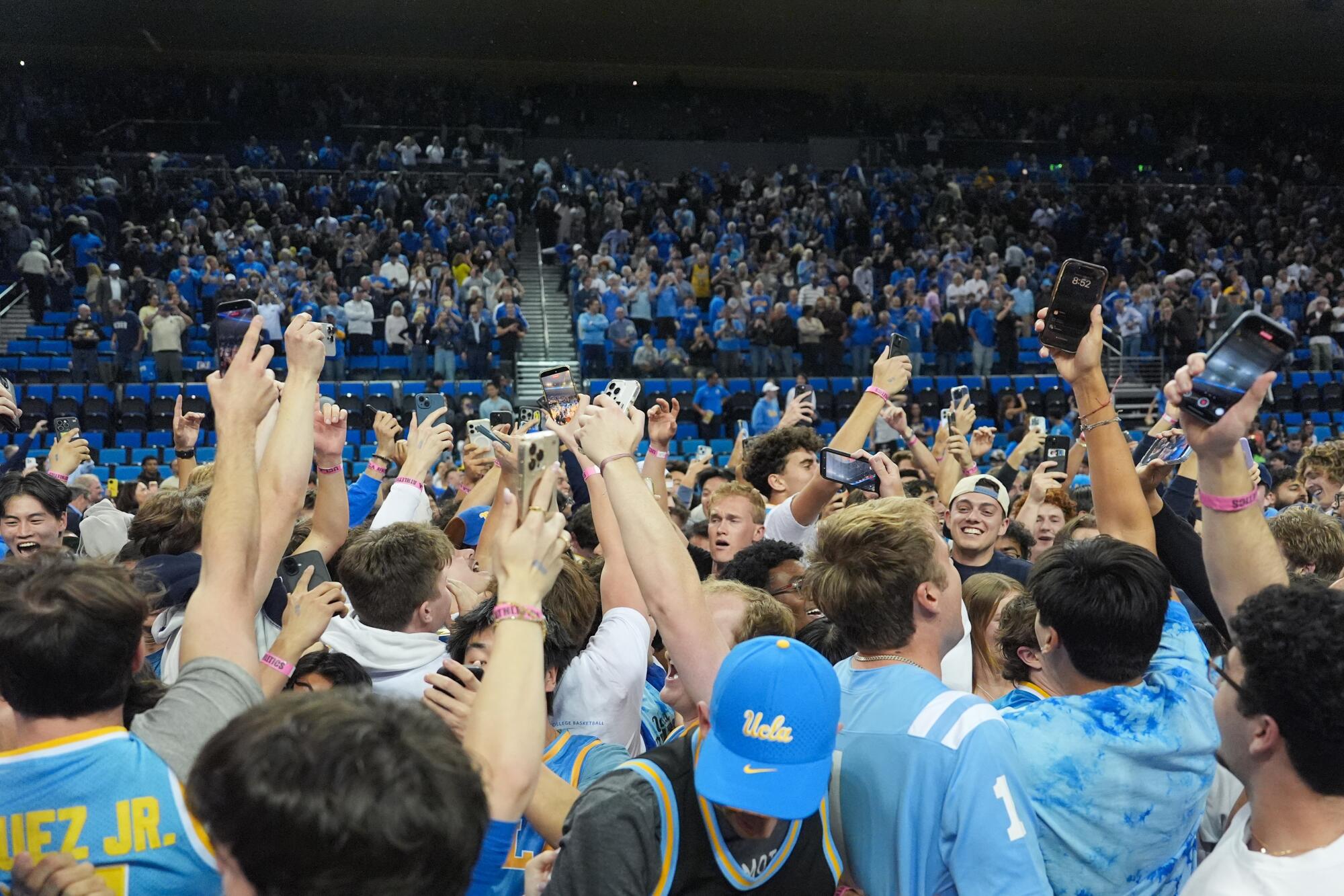 UCLA fans storm the court after the team defeated No. 4 Purdue at Pauley Pavilion on Tuesday.