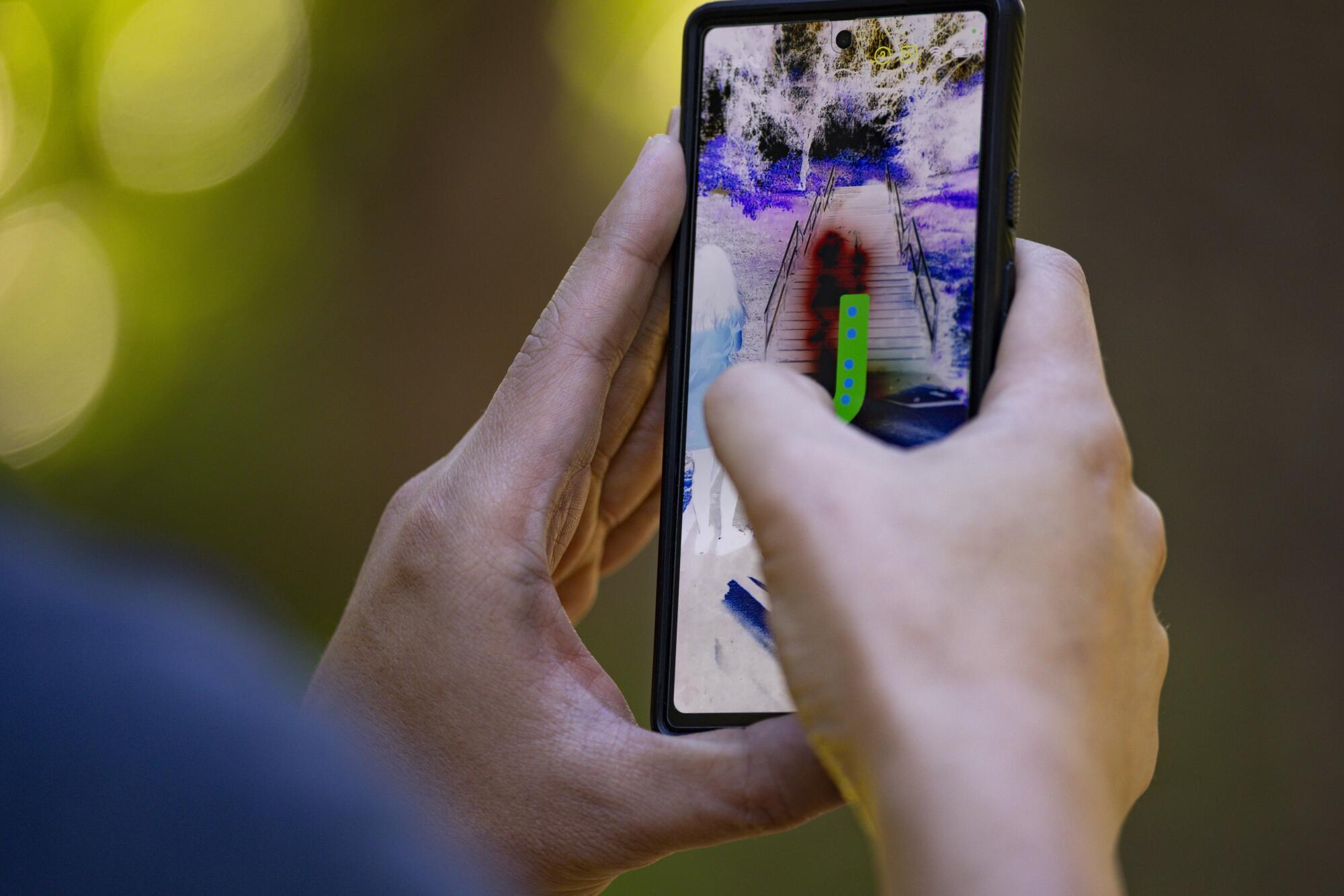 A person on a mobile phone traces out on the display.
