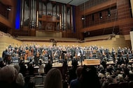 A standing ovation begins for the Dallas Symphony Orchestra's performance of Anton...