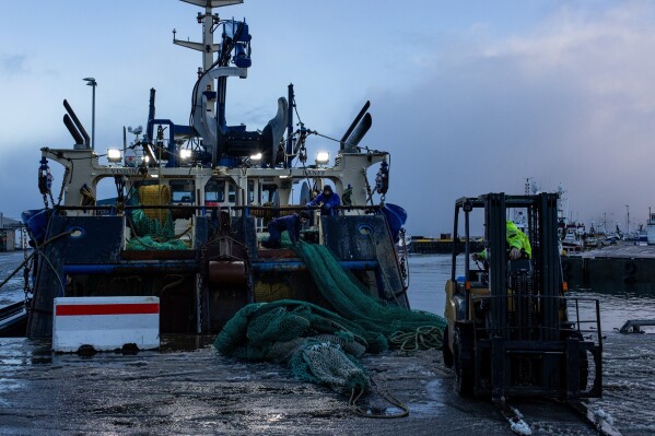Fisherman work on a boat in the North Sea on Jan. 5, 2026, in Fraserburgh, a fishing town in northeastern Scotland. (AP Photo/Emily Whitney)