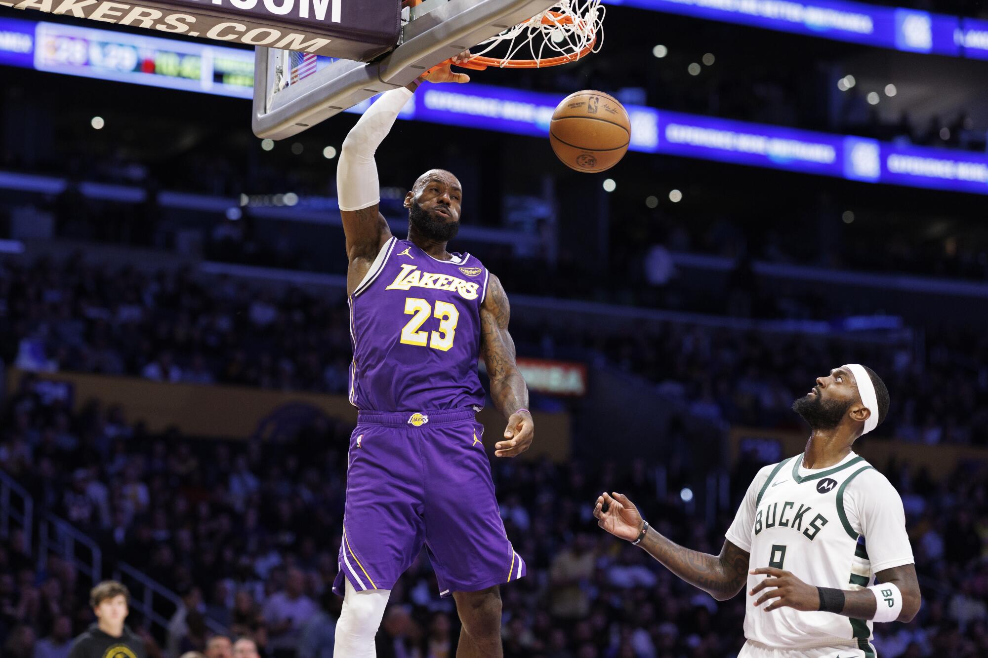 Lakers star LeBron James dunks over Milwaukee Bucks forward Bobby Portis on Jan. 9 at Crypto.com Arena.
