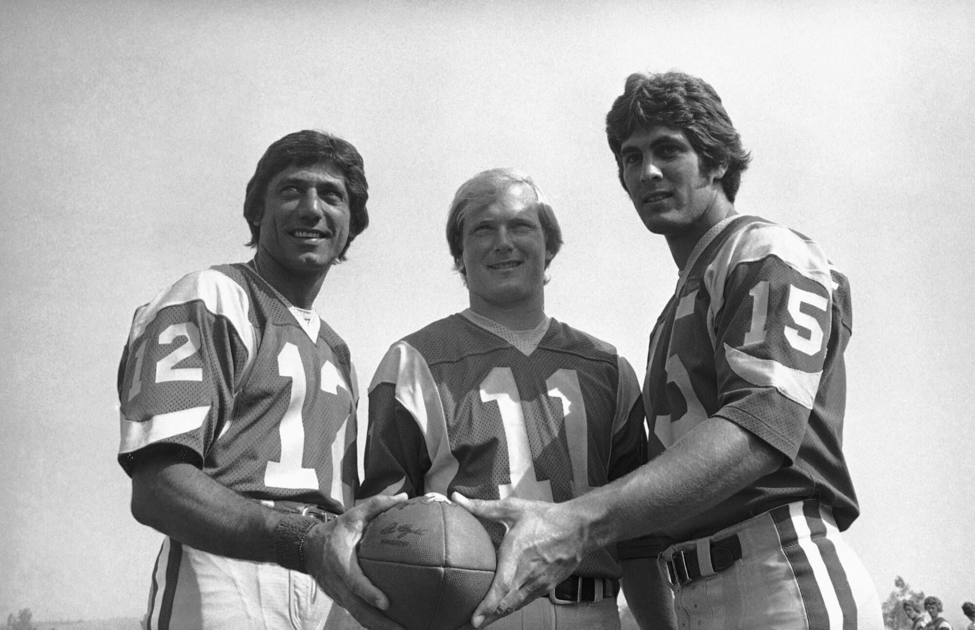 Rams quarterbacks (from left) Joe Namath, Pat Haden and Vince Ferragamo pose for a photo at Cal State Fullerton.