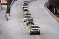 Drivers follow a single line as they merge onto North Central Expressway during a winter...
