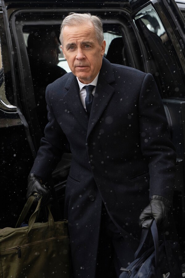 Canadian Prime Minister Mark Carney arrives by motorcade to Parliament Hill in Ottawa, Tuesday, Jan. 27, 2026. (Adrian Wyld/The Canadian Press via AP)