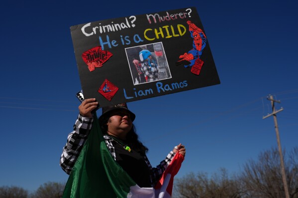 Protesters gather outside the South Texas Family Residential Center detention facility where Liam Ramos and his father are being detained in Dilley, Texas, Wednesday, Jan. 28, 2026. (AP Photo/Eric Gay)
