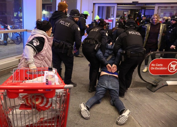 A protester is detained and removed from the Target store in Chicago's West Loop, Jan. 29, 2026. (Terrence Antonio James/Chicago Tribune)