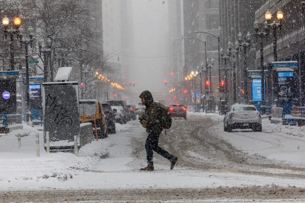People walk in Chicago's Loop as a winter storm passes through on Jan. 25, 2026. (Armando L. Sanchez/Chicago Tribune)