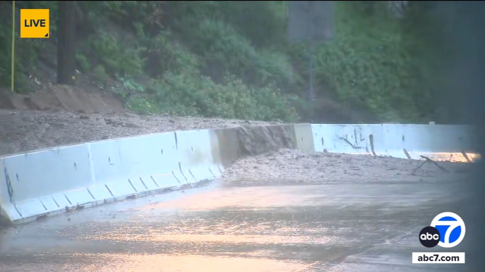 Water, mud rushes over barrier onto Altadena street