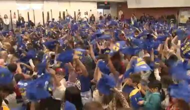 Los Angeles Rams hand out rally towels to fans ahead of playoff game against the Carolina Panthers