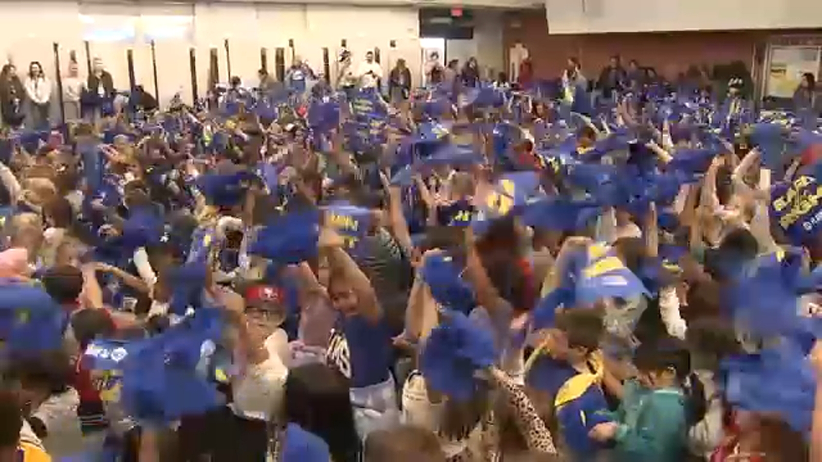 Los Angeles Rams hand out rally towels to fans ahead of playoff game against the Carolina Panthers