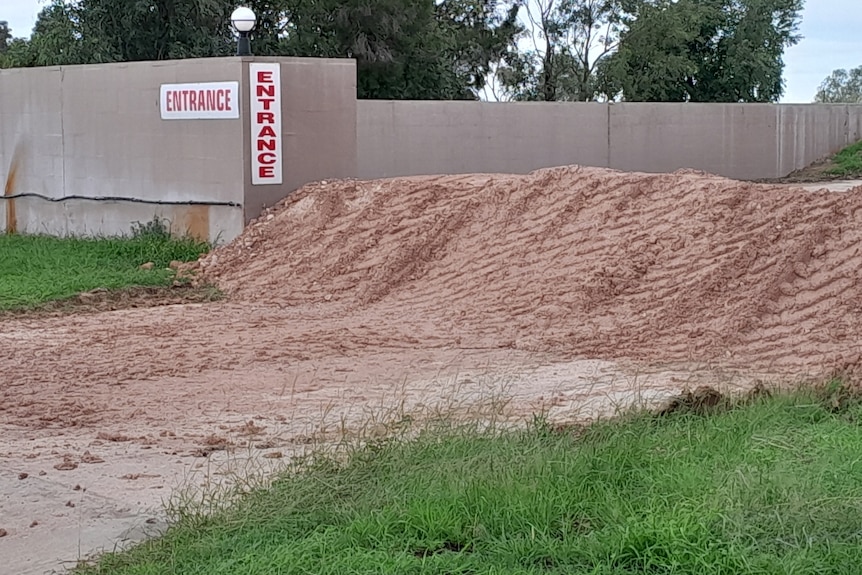 mount of dirt in entrance to motel