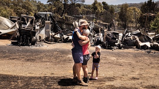 CFA volunteer Raewyn Rice greets her son after fighting fires all night and returning to her own home to find it was a twisted, blackened ruin.