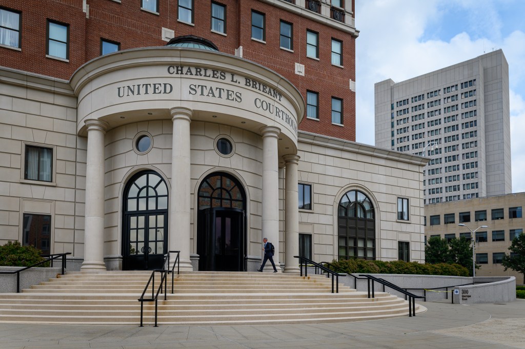 A person walks into the Charles L. Brieant United States Courthouse in White Plains, New York.