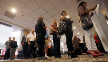 People line up to attend a State Farm Career Fair, Tuesday, Aug. 4, 2015, in Phoenix.