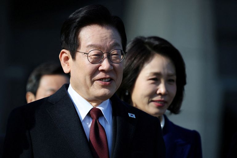 South Korean President Lee Jae Myung and his wife Kim Hye-kyung arrive at Seoul Air base as they leave for Beijing, in Seongnam, South Korea