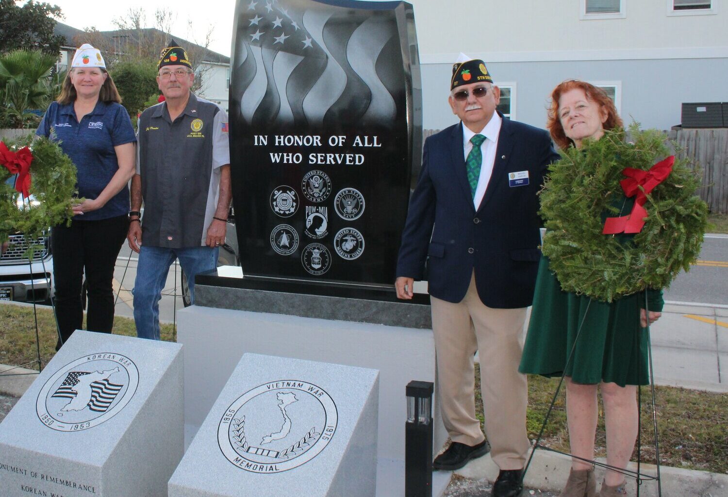 Pictured from left, American Legion Department of Florida Commander Jessica Moore, Ocean Beaches Post 129 Commander Jeff Durden, American Legion District 5 Commander Miguel Garcia and American Legion Auxiliary Unit 129 President Cindy Jordan take part in the official unveiling of monuments honoring beaches military service personnel killed in action in undeclared wars, at Ocean Beaches Post 129 in Jacksonville Beach.