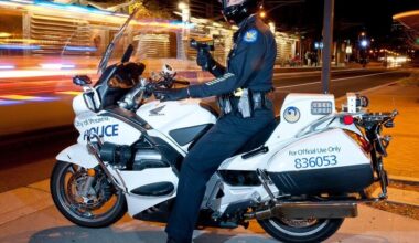 A Phoenix Police officer checks vehicles