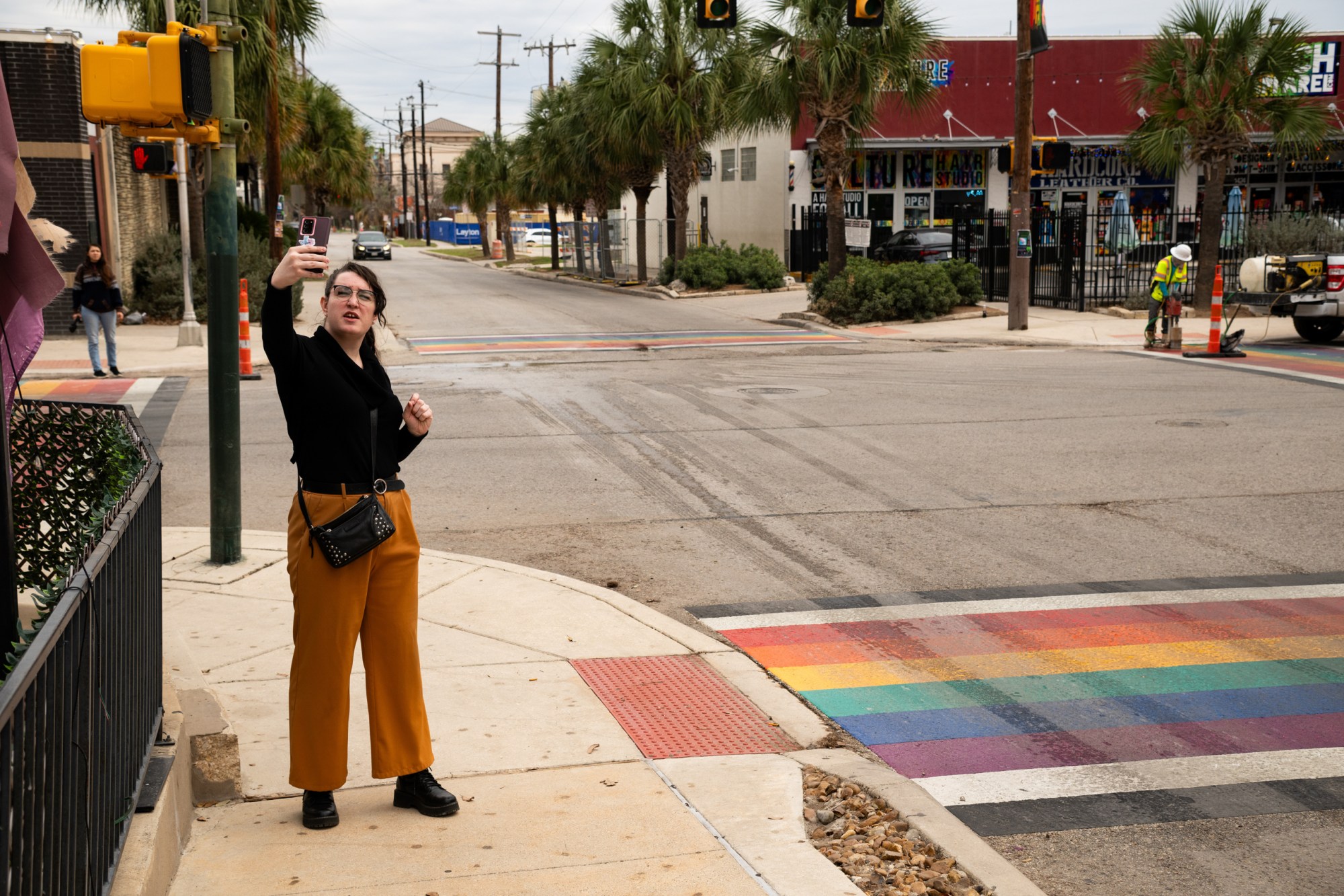 Matilda Miller, 6W Project President, records a video about the beginning of the rainbow crosswalk removal at North Main Avenue and Evergreen Street on Jan. 12, 2026 in San Antonio.
