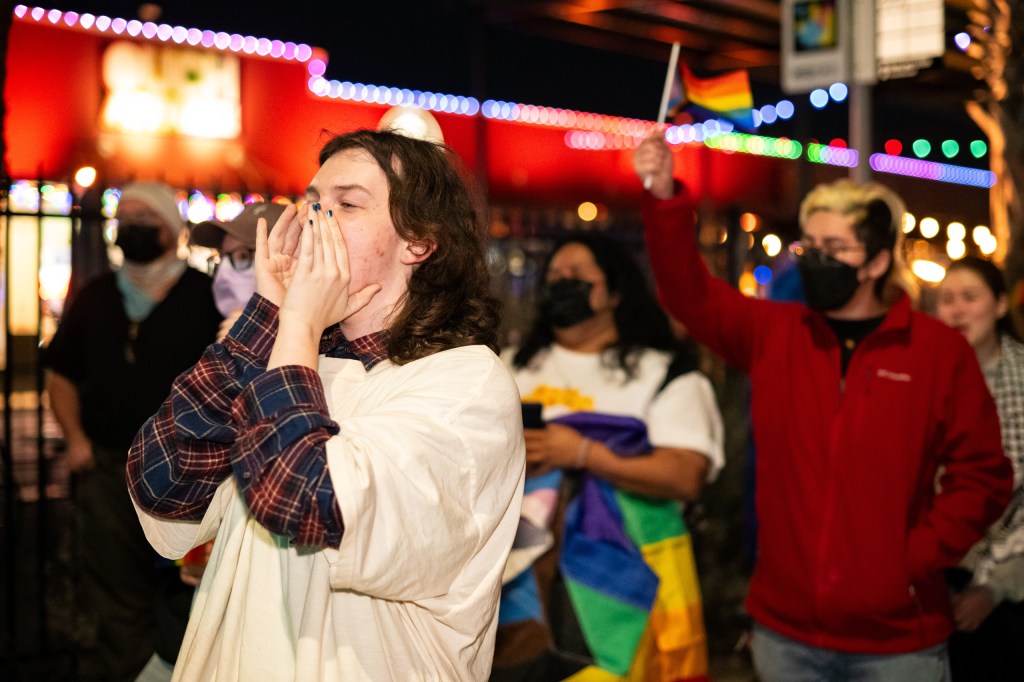 Spencer, 6W Project member, cheers at a demonstration protesting the removal of the rainbow crosswalk.