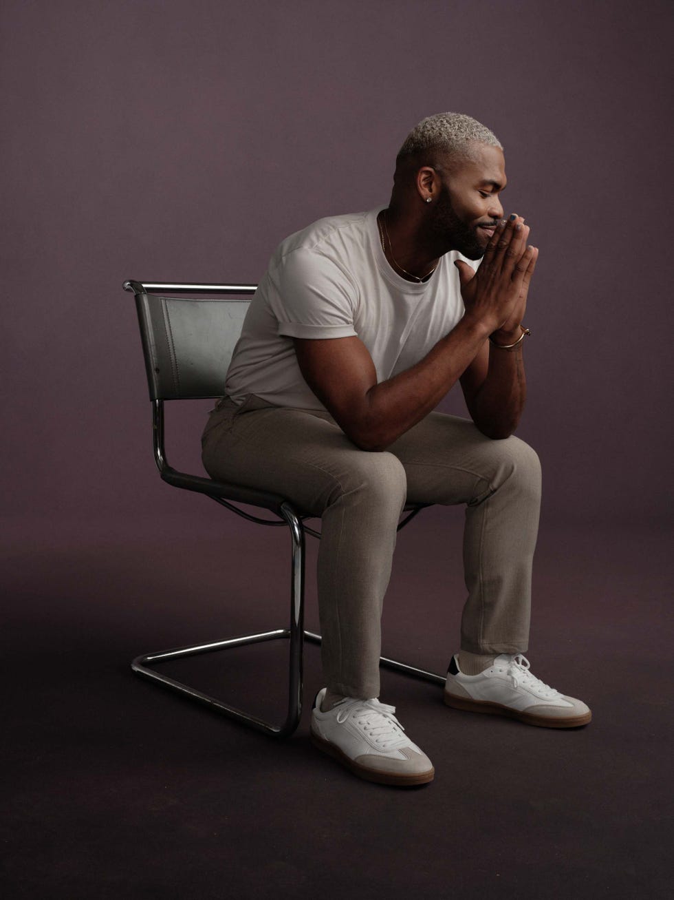 gilead x men's health a person seated on a modern chair appearing contemplative