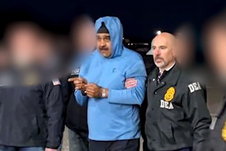 Nicolas Maduro is escorted by DEA Agents