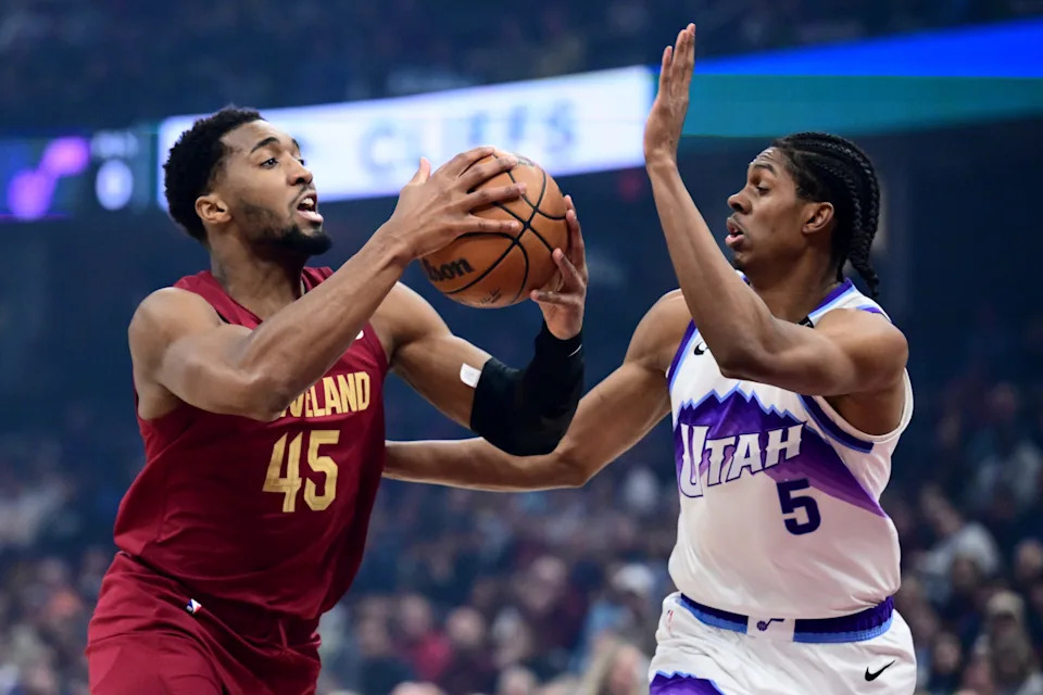 Jan 12, 2026; Cleveland, Ohio, USA; Cleveland Cavaliers guard Donovan Mitchell (45) drives to the basket against Utah Jazz forward Cody Williams (5) during the first quarter at Rocket Arena. Mandatory Credit: Ken Blaze-Imagn Images