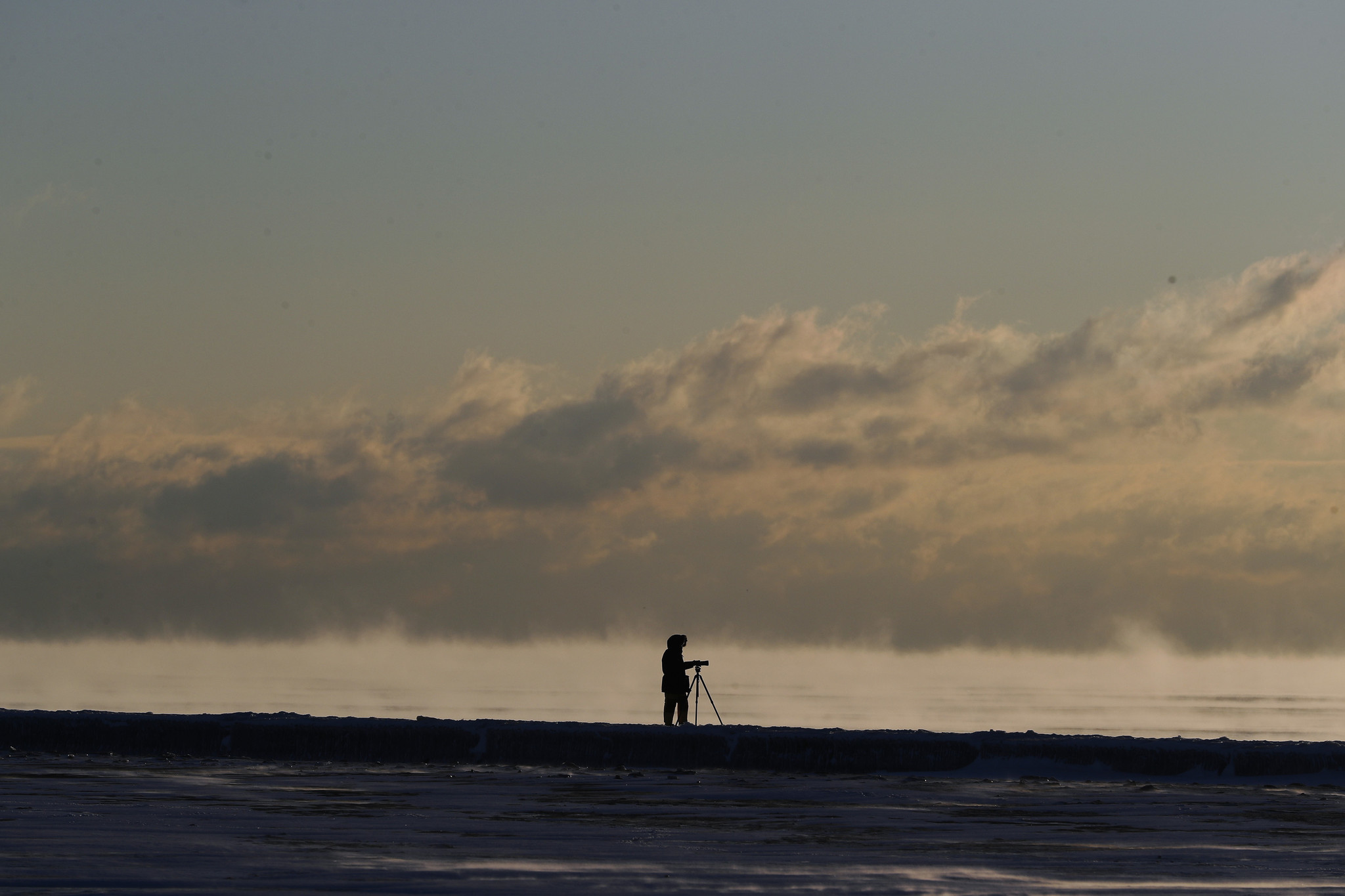 A photographer watches the sun rise on the Chicago lakefrontÂ at...