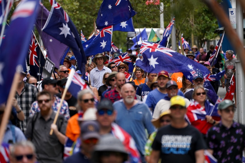 People waving Australian flags rallied against immigration into Australia on January 26, 2026.