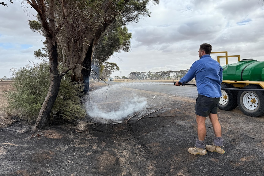 Natimuk farmer Dylan Rethus battles a roadside fire.