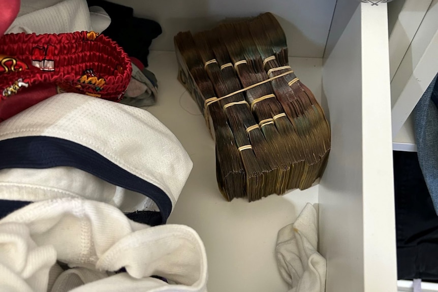 A wad of cash in a drawer