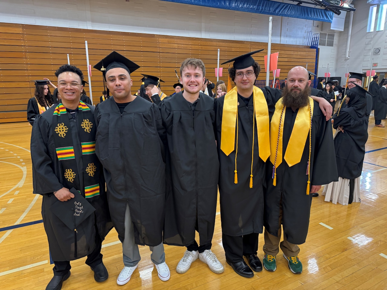 Electromechanical technology degree program graduates who will work at Micron in Boise, Idaho attend Onondaga Community College commencement in the SRC Arena on Saturday, May 17, 2025.(Left to right) RJ Tinsley, Kah-lelle Akins, Hunter Garrett, Sam Pandossi, and Timothy Szarek.