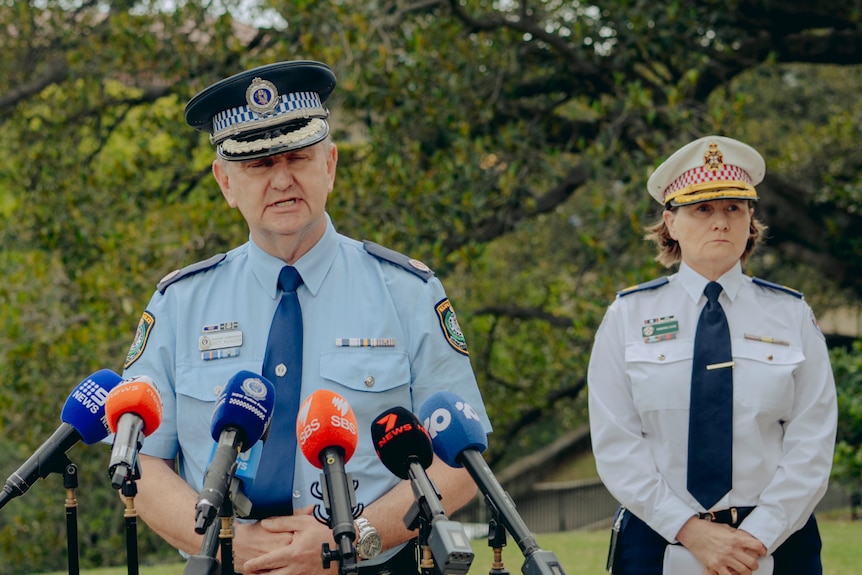 A man in police uniform addresses media