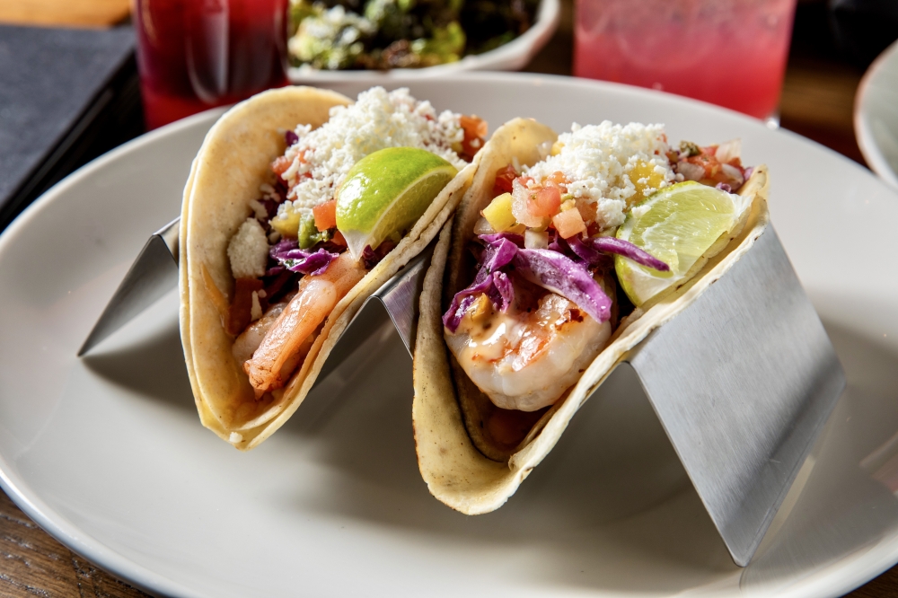 On the Kirb's shrimp tacos ($14) include grilled shrimp topped with purple slaw, queso fresco, pineapple pico, lime and sweet tangy dynamite sauce. (Courtesy On the Kirb)