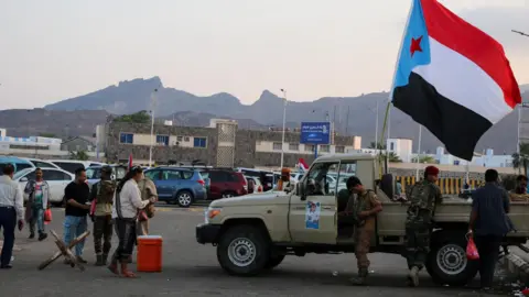 Reuters A flag of the UAE-backed separatist Southern Transitional Council (STC) flutters on a military pick-up truck at a rally by STC supporters in Aden, Yemen (1 January 2026)