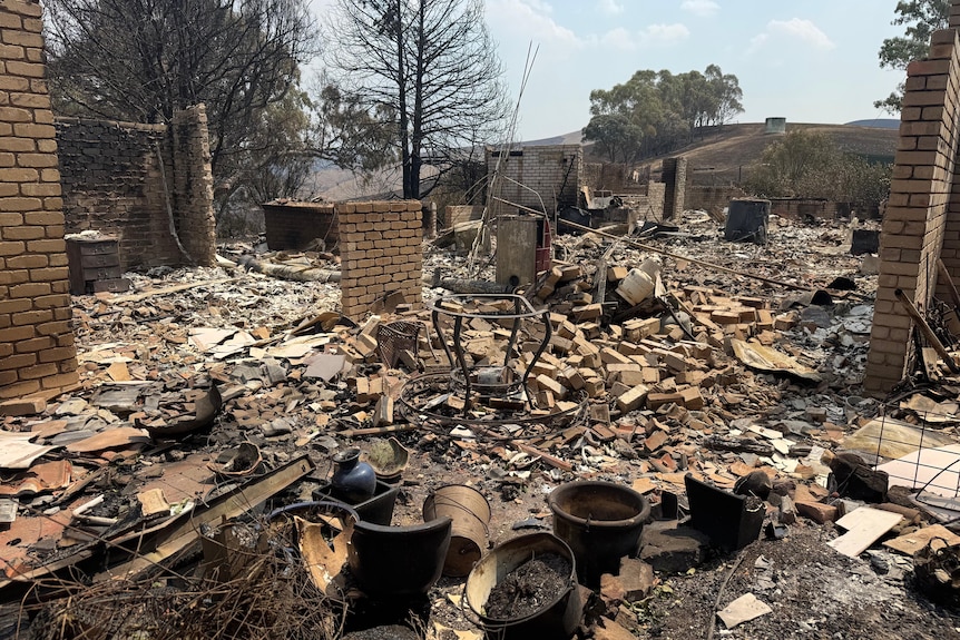 A burnt out house with lots of rubble.