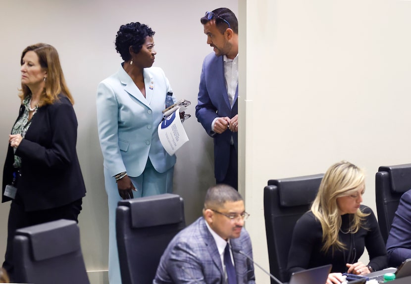 Dallas City Manager Kimberly Bizor Tolbert (standing, center) visits with Deputy Mayor Pro...