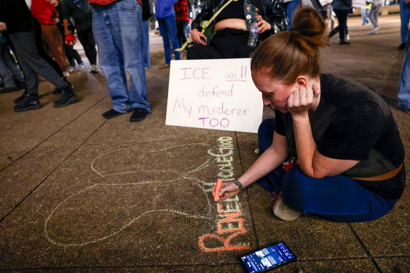 Pepper Haynes, 37, draws a butterfly with Renee Nicole Good’s name during an ‘ICE Out Now’...
