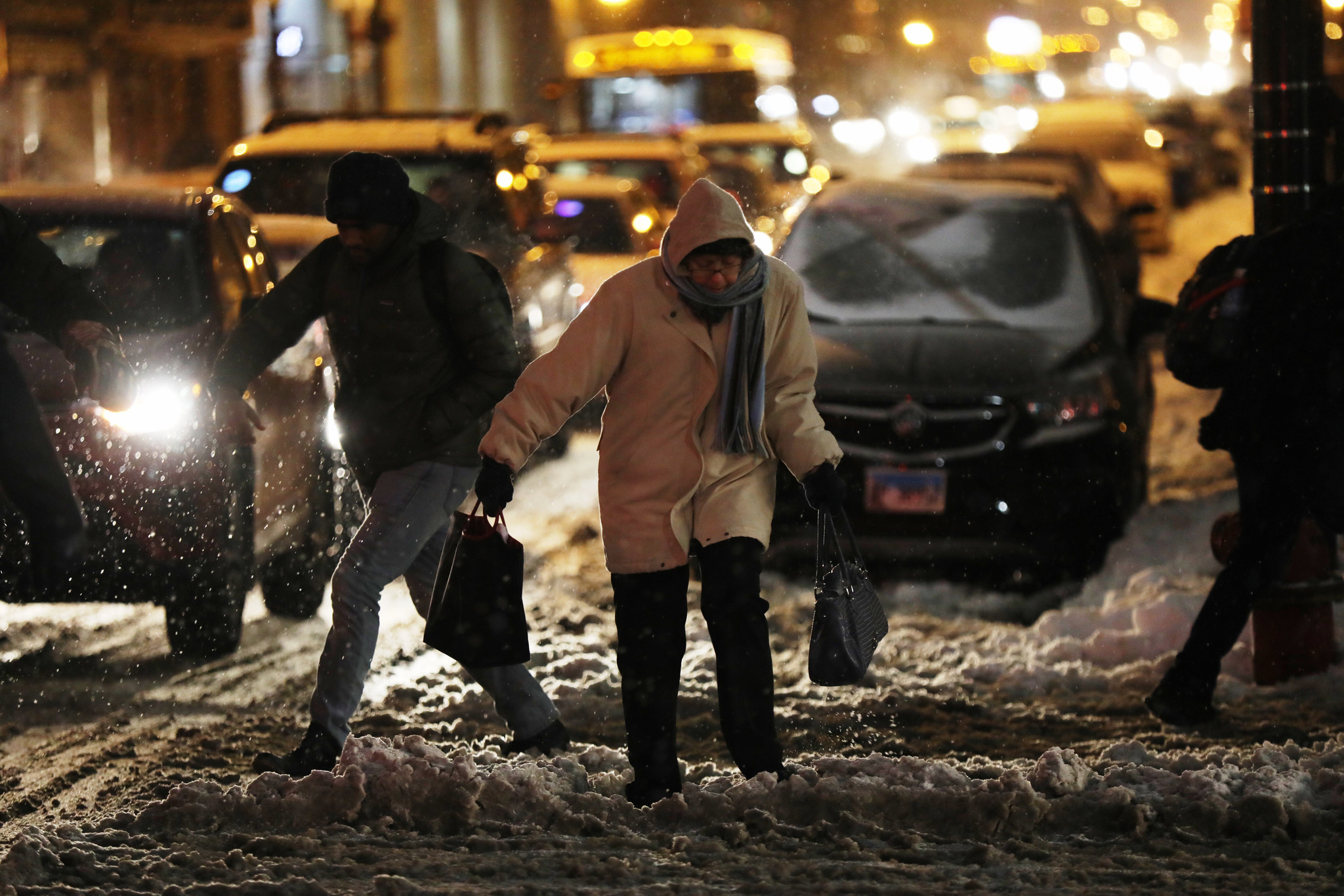 Pedestrians contend with snow and cold weather at Clinton Street...