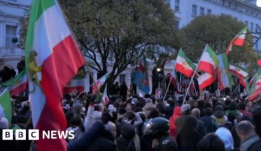 Protester climbs onto balcony of Iranian embassy in London