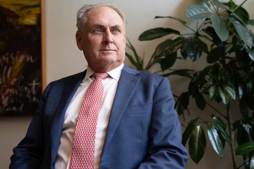 Don Farrell wearing a suit and tie looks off into the distance.